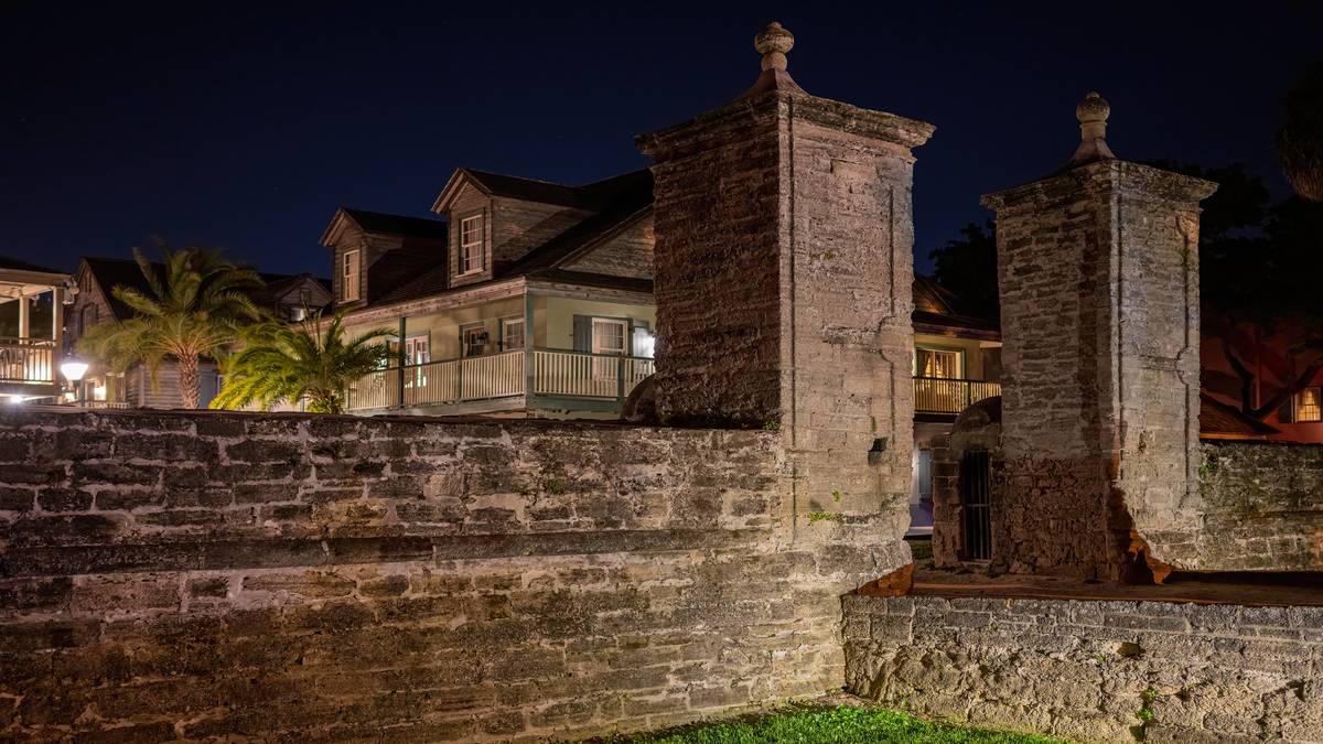 Stone Gates at night with old home in background